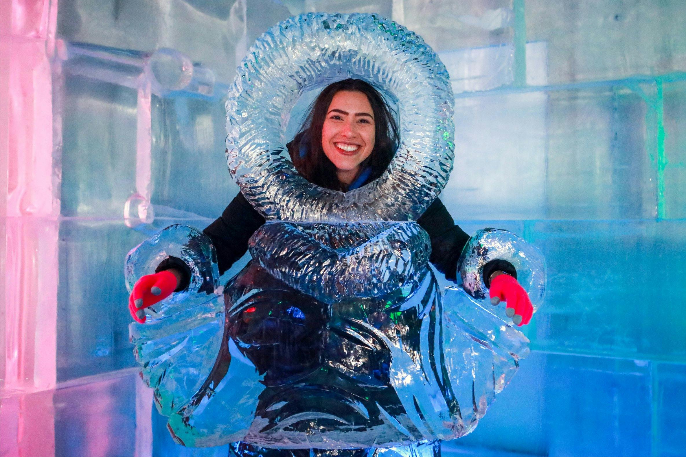 Smiling woman posing with ice sculpture in Below Zero